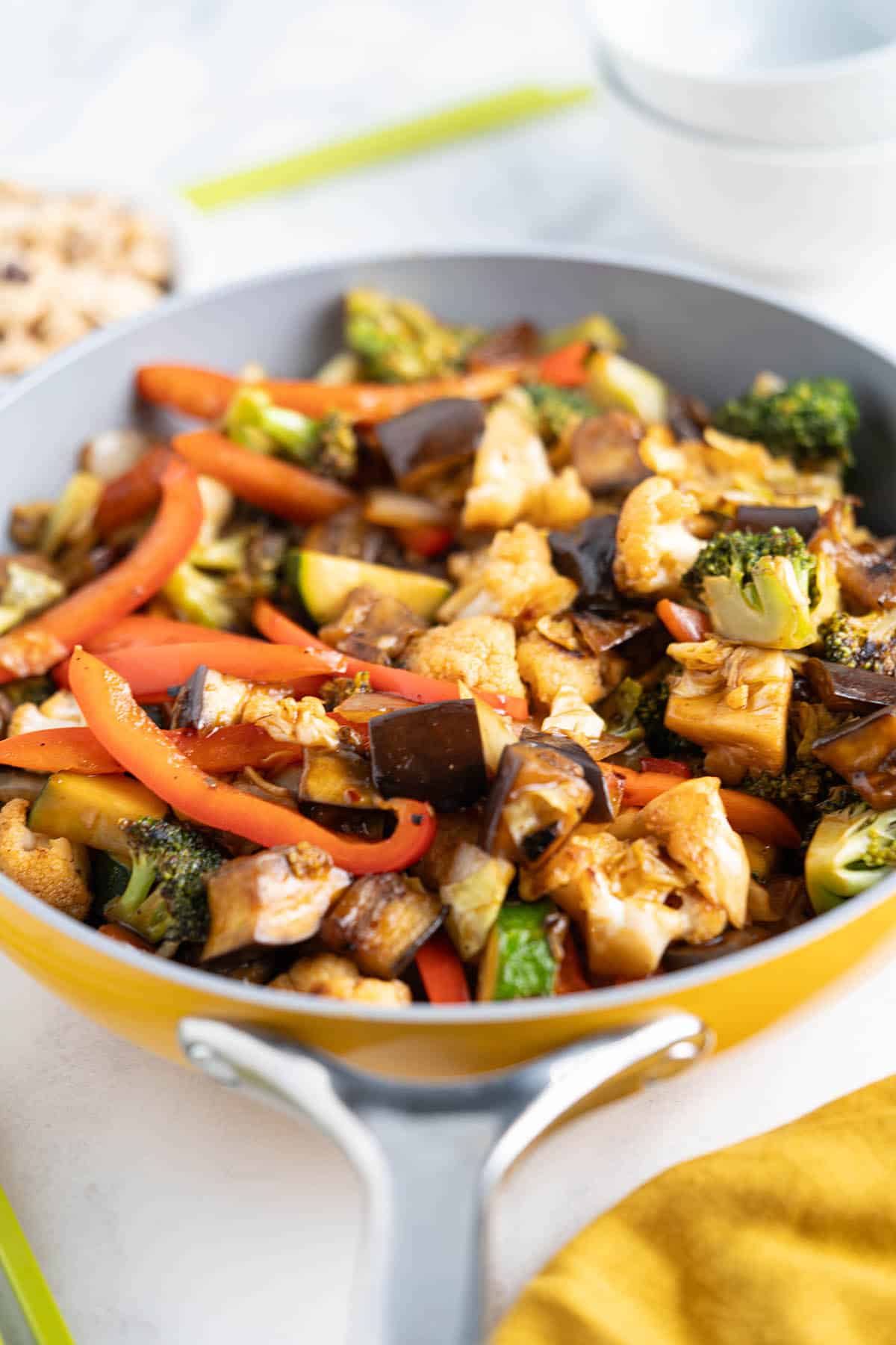 Stir fry vegetables in a spicy sauce in a fry pan.