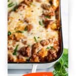 Baked ravioli casserole hot and bubbly and ready to eat. With print overlay for Pinterest.