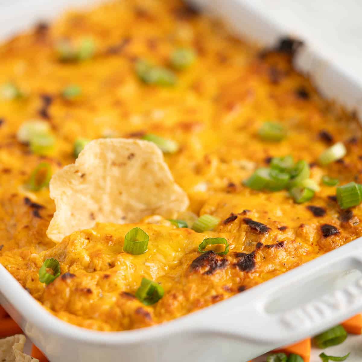 A casserole dish filled with a cheesy dip.