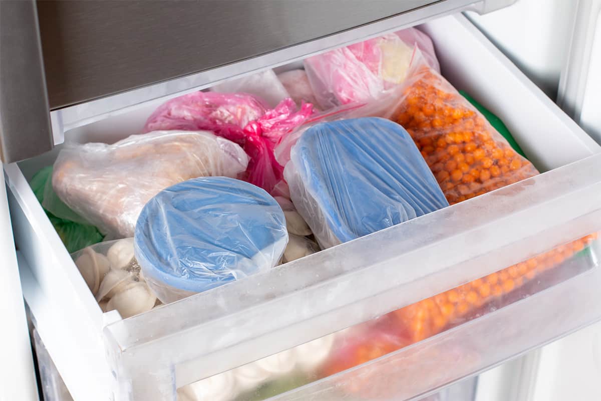 Containers of frozen food in the freezer.
