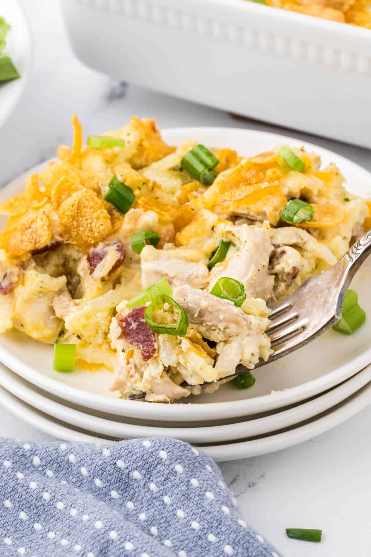 Hashbrown Chicken Casserole on a plate with a fork. 