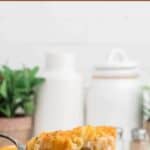 Cheesy Chicken Tater Tot Casserole in a baking dish with a serving spoon taking a big scoop. With print overlay for Pinterest.