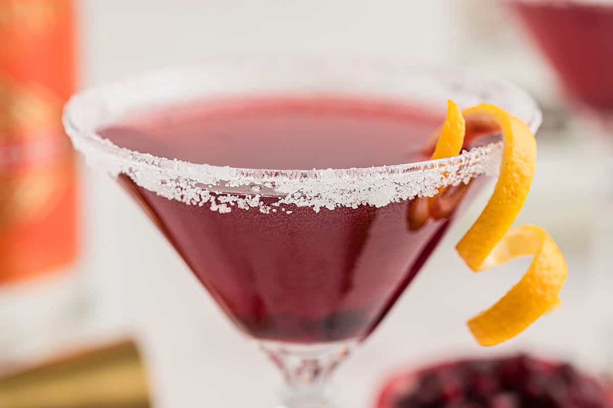 A Carrabas Pomegranate Martini Step garnished with a twist of orange.