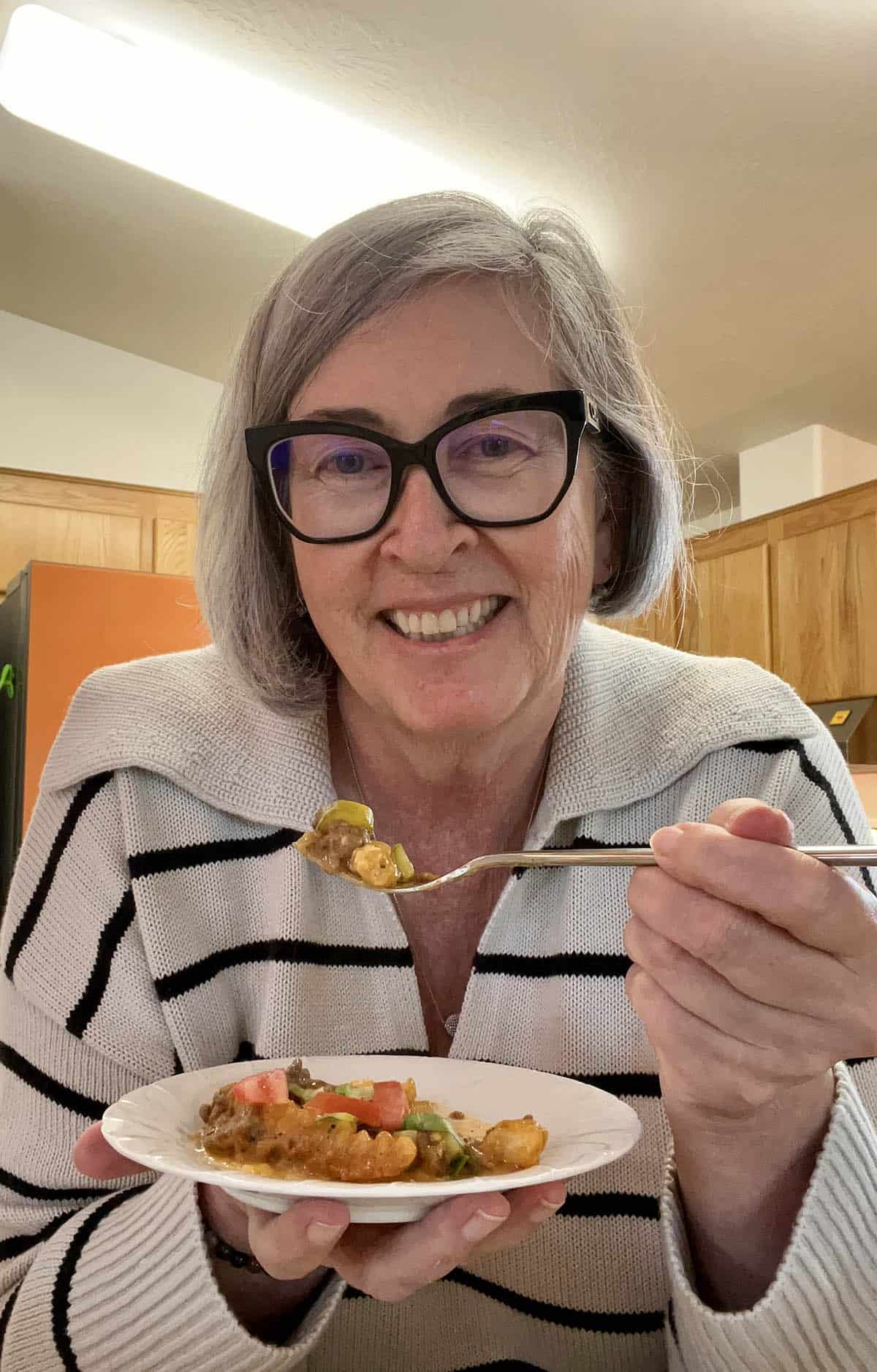 Food Blogger Deb Clark eating the Cheeseburger French Fry Casserole.
