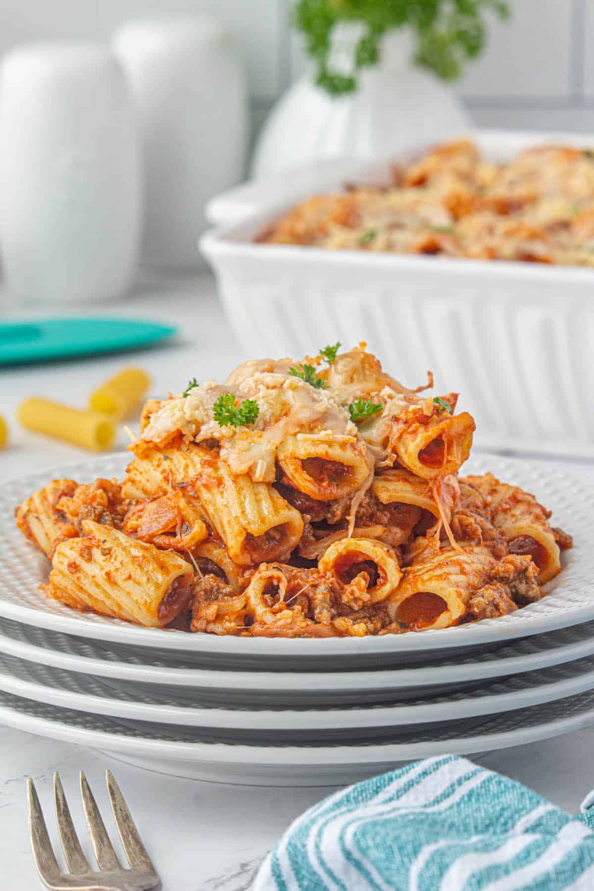 A big serving of a cheesy pasta casserole on a plate.