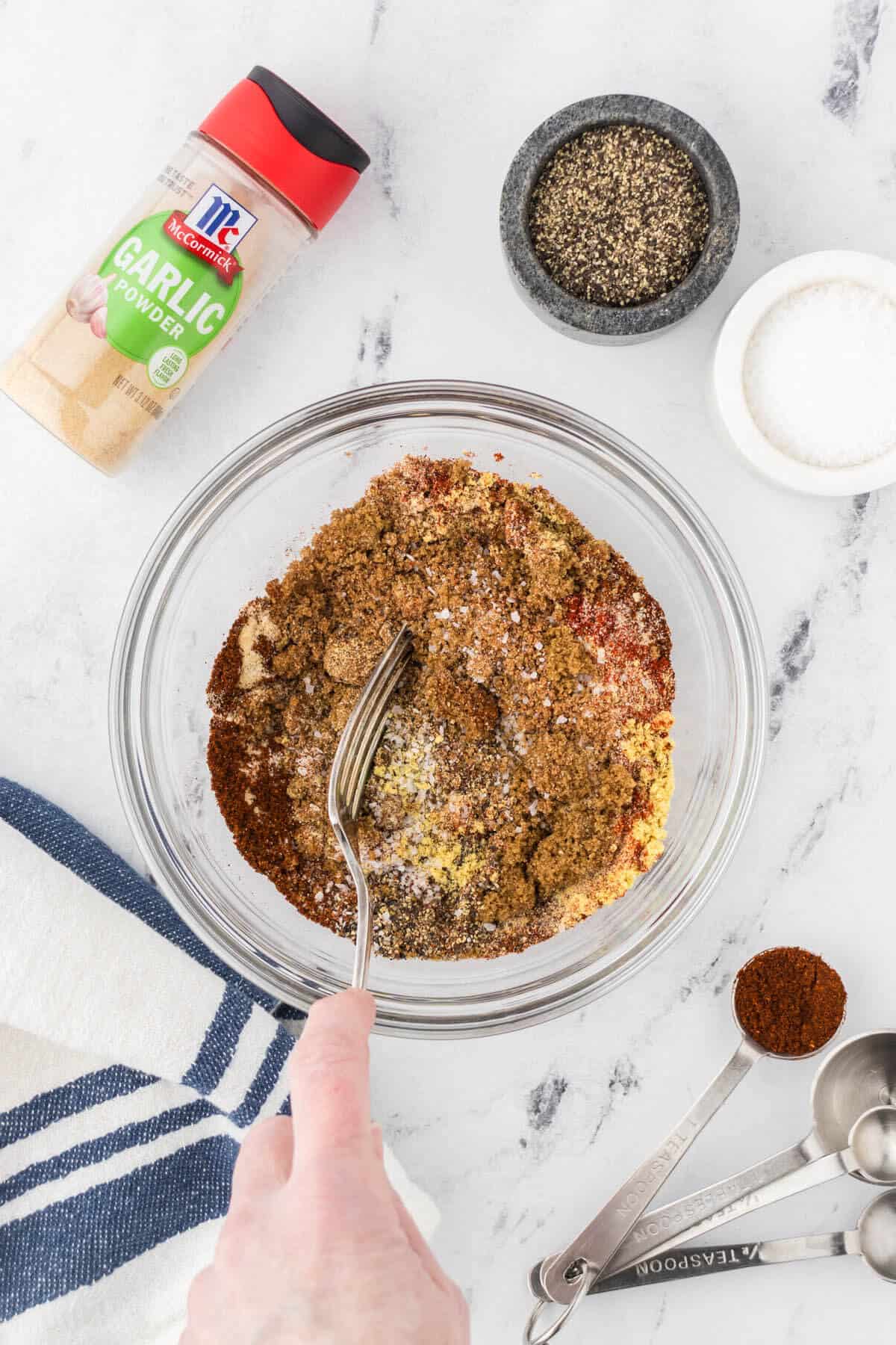 Spices being mixed in a bowl.