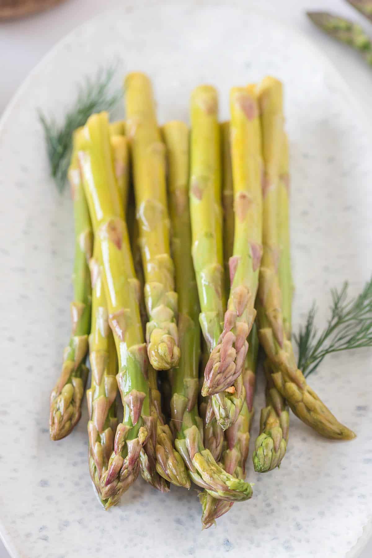 A platter piled with pickled asparagus.