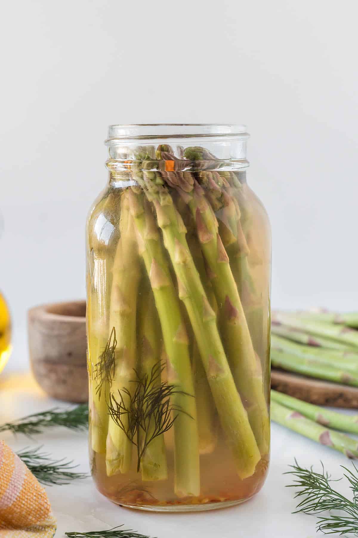 Spicy pickled asparagus in a jar.