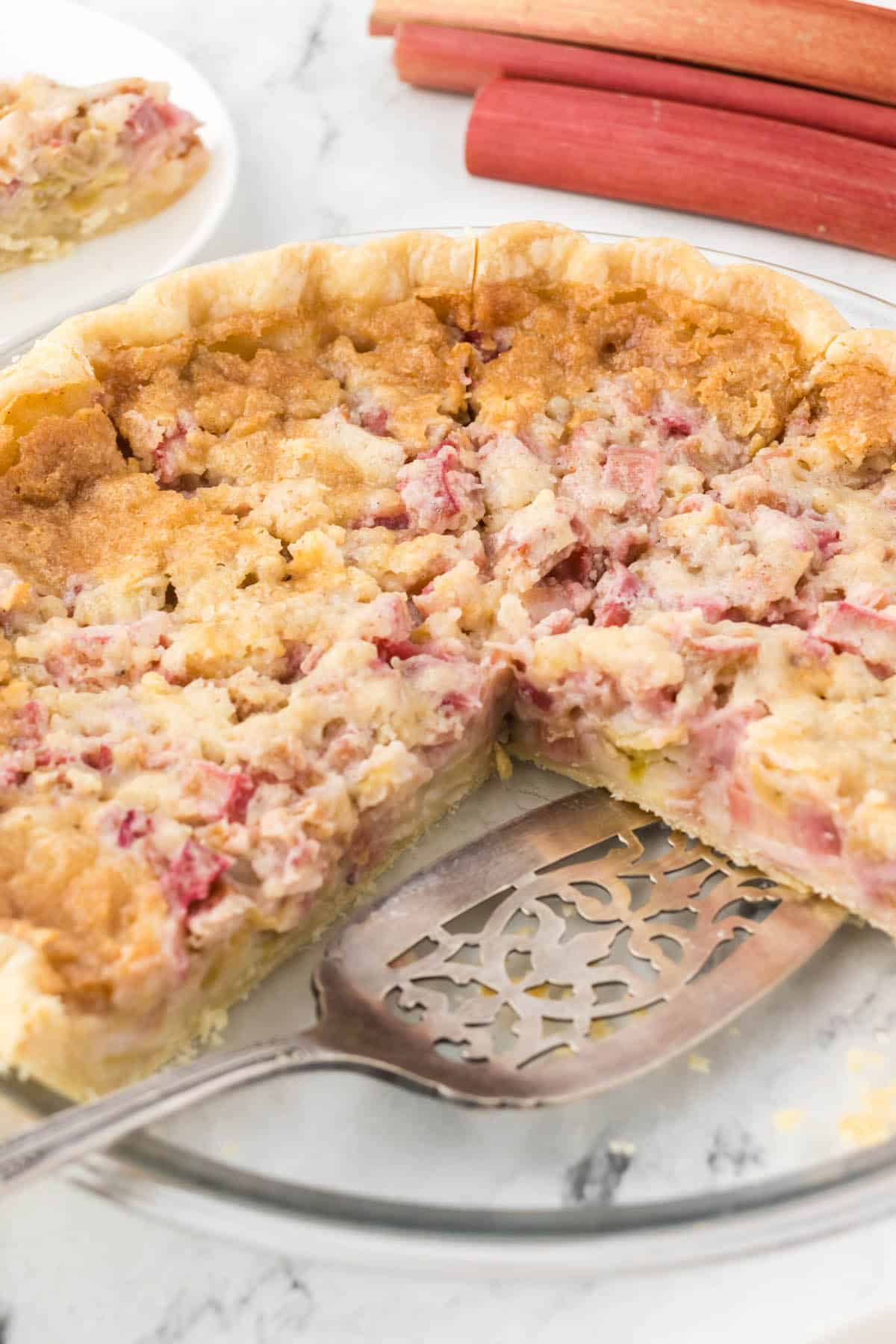 Cream of Rhubarb Pie in a pie plate with knife.