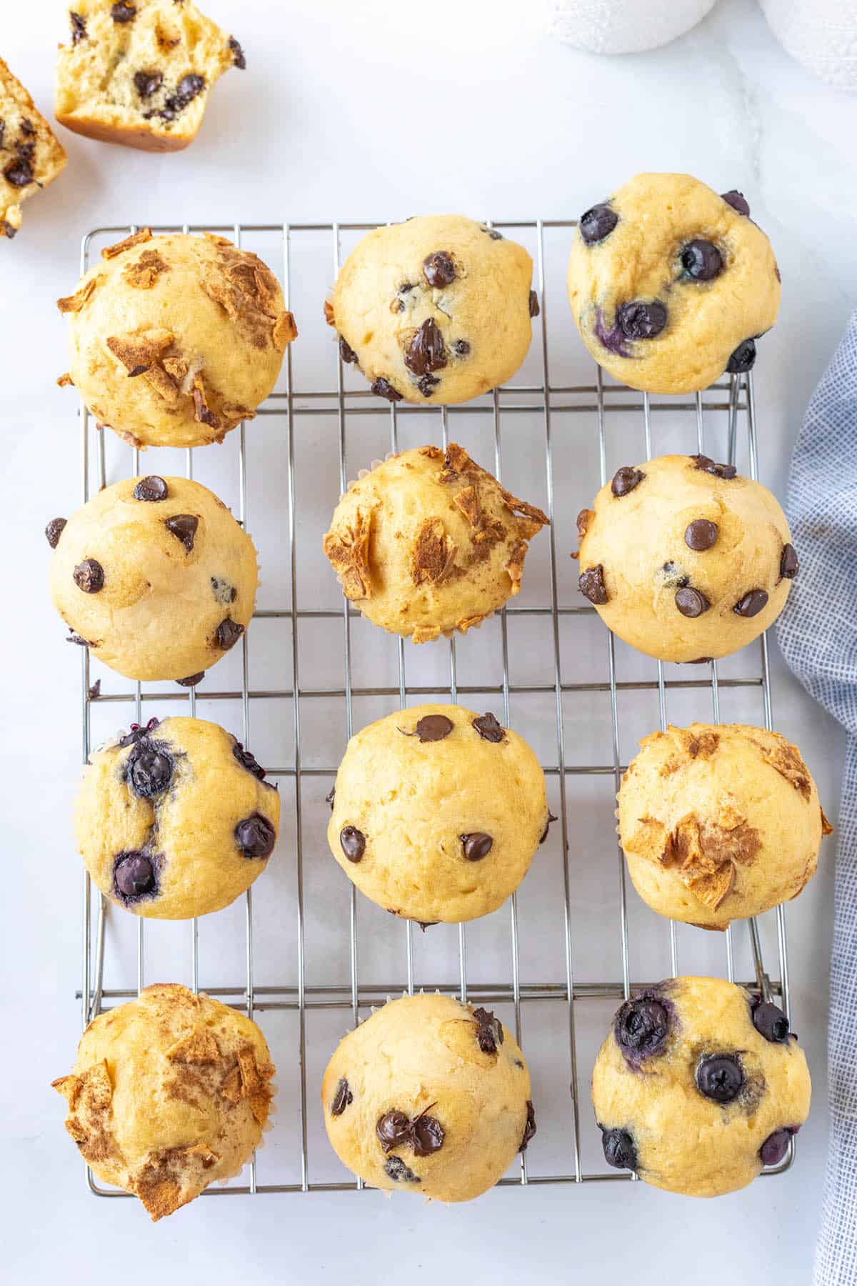 Blueberry, chocolate chip and granola pancake mix muffins on a cooling rack.