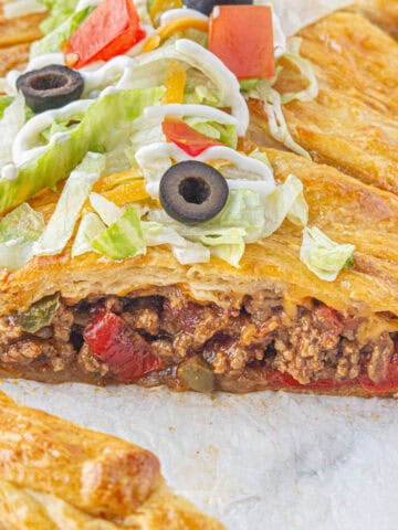 Fajita taco braid, filled with seasoned ground beef, wrapped in a buttery crescent roll dought and baked until golden brown.
