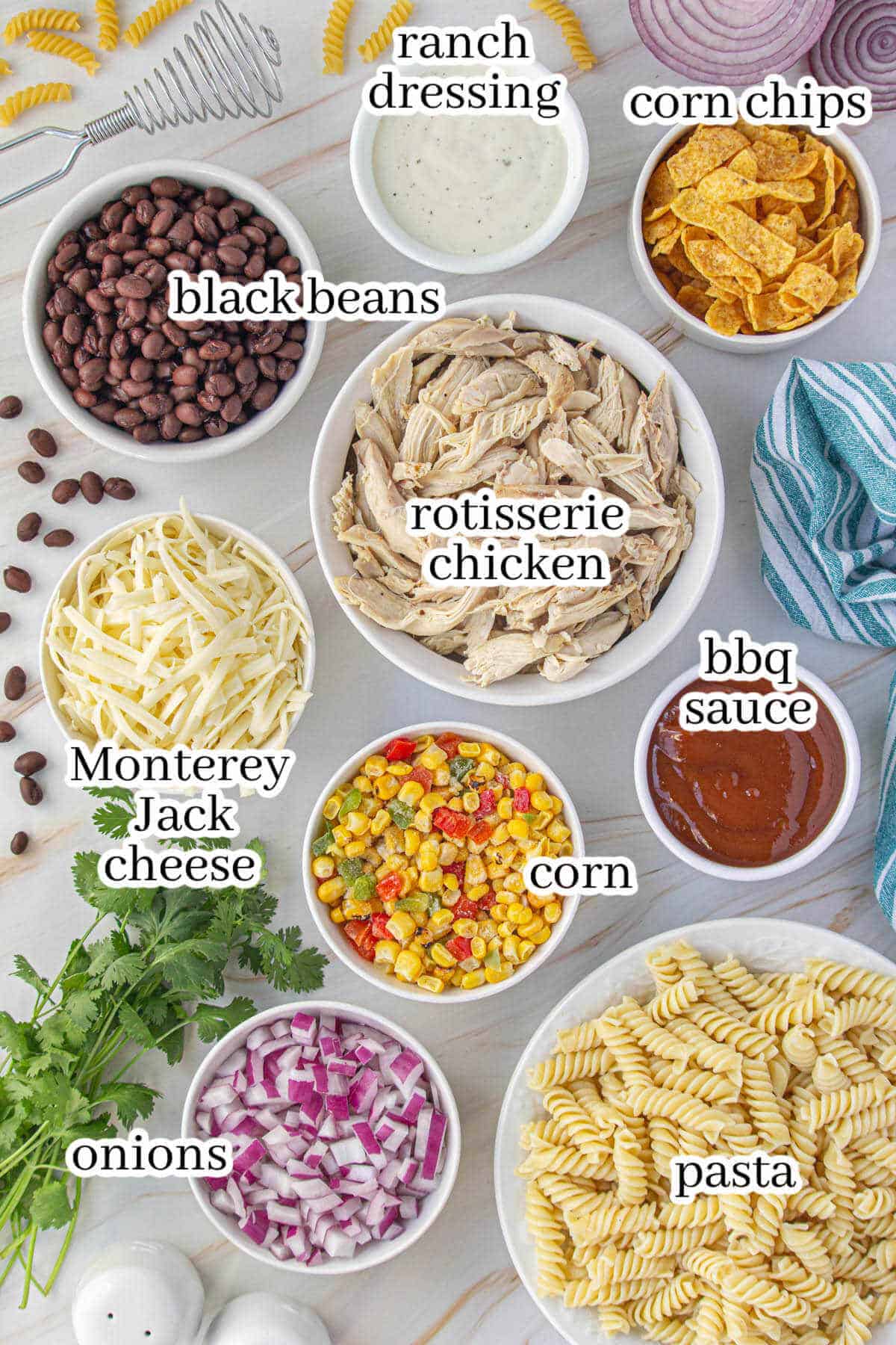 All of the ingredients needed to make the pasta salad recipe, with print overlay for clarification.