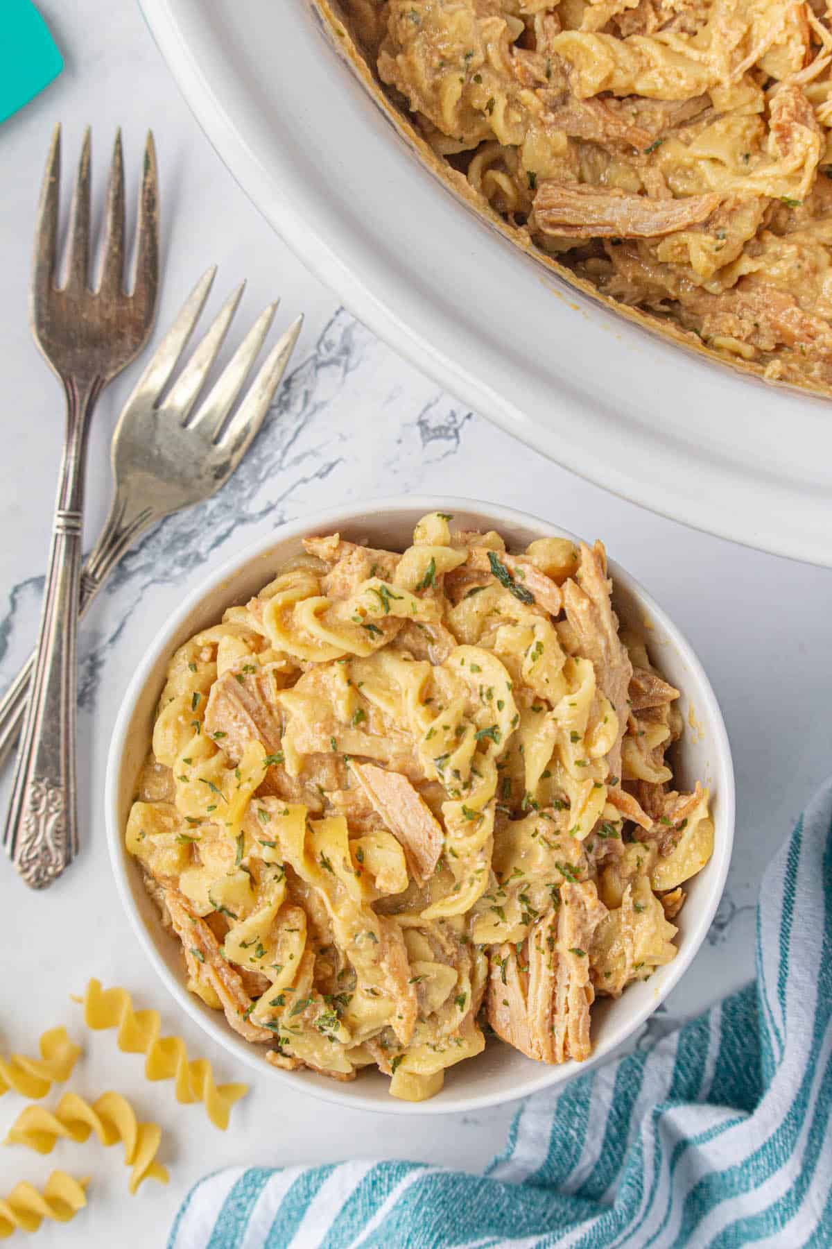 Rich and creamy chicken and noodles in a bowl.