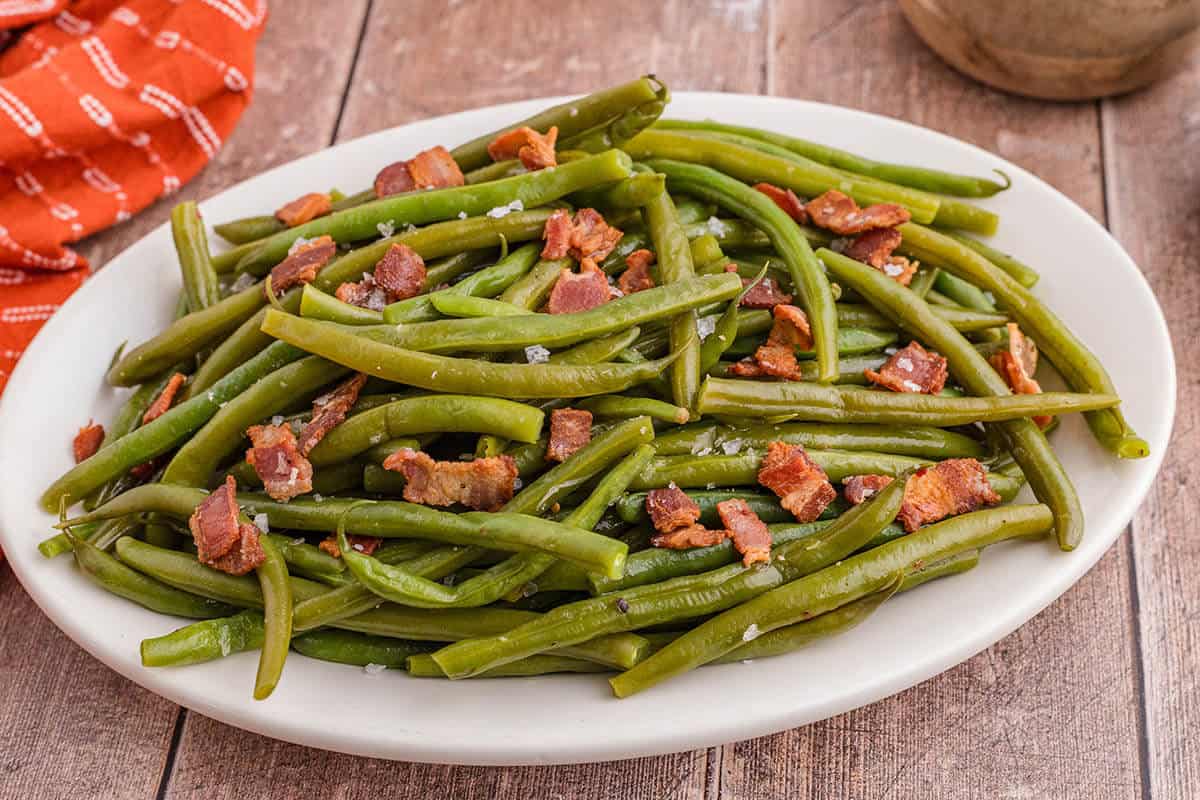 A platter filled with crack green beans, ready to eat.