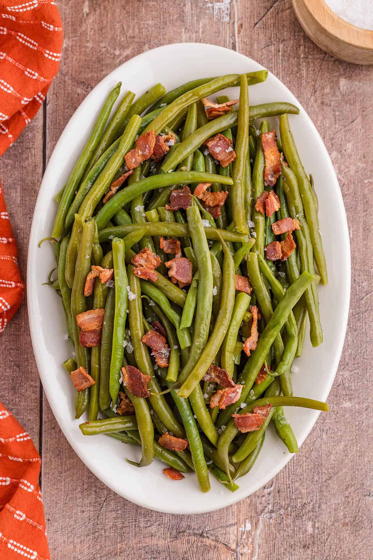 Copycat Cracker Barrel green beans and bacon on a platter.