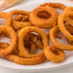 Air fried onion rings on a platter.