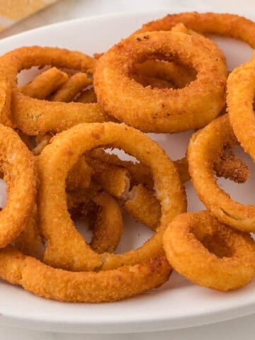 Air fried onion rings on a platter.