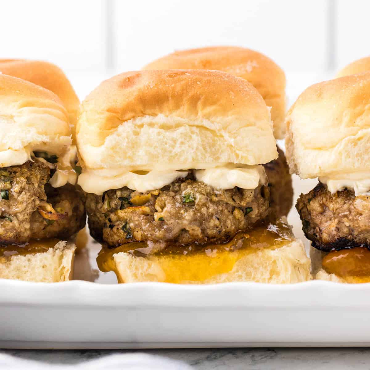 Ground turkey sliders on Hawaiian rolls on a platter.