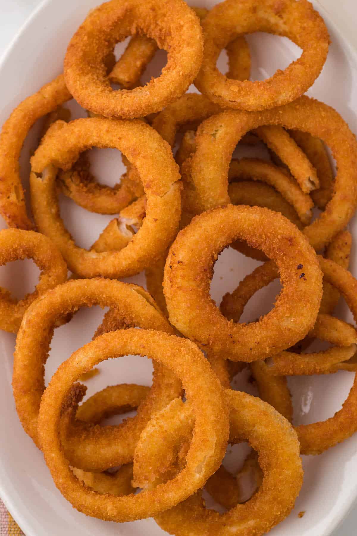 A platter heaped with air fryer onion rings.