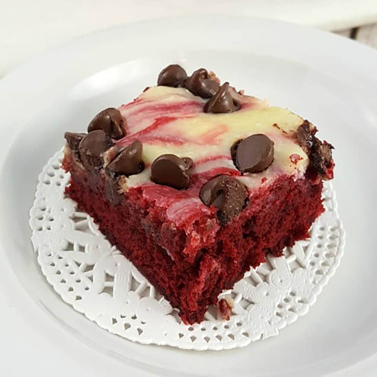 Red Velvet Cheesecake Bar on a white plate. 