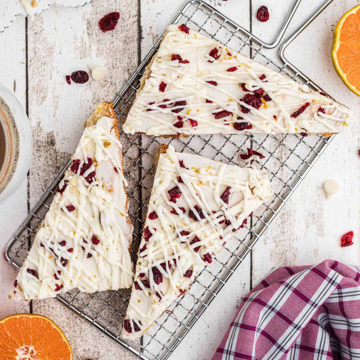 Copycat Starbucks Cranberry Bliss Bars sliced and on a cooling rack. 