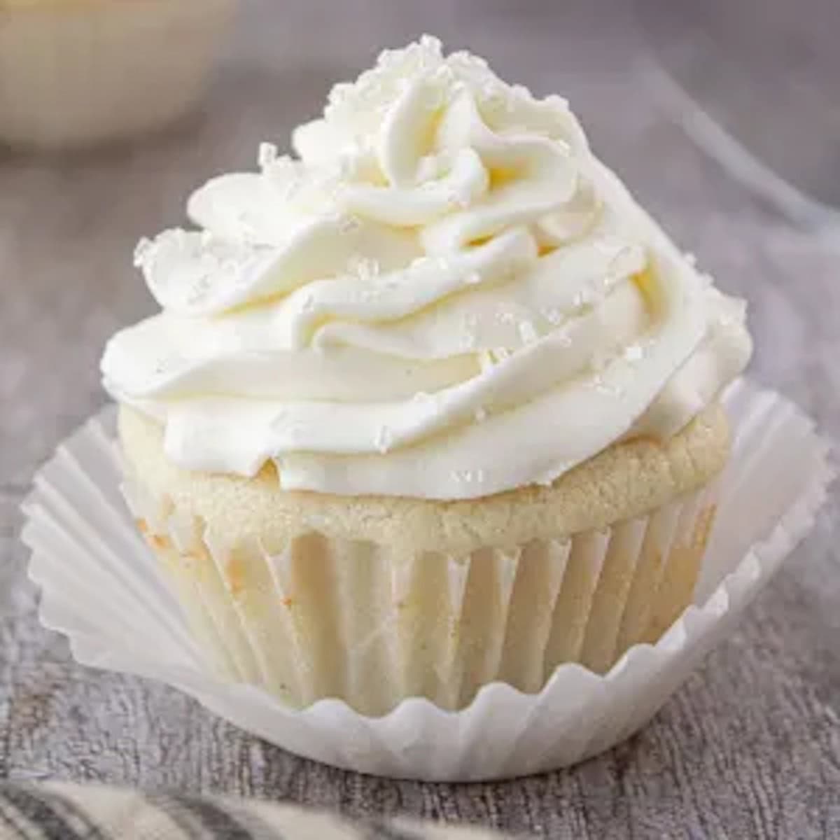 White cupcake with a white sour cream frosting.