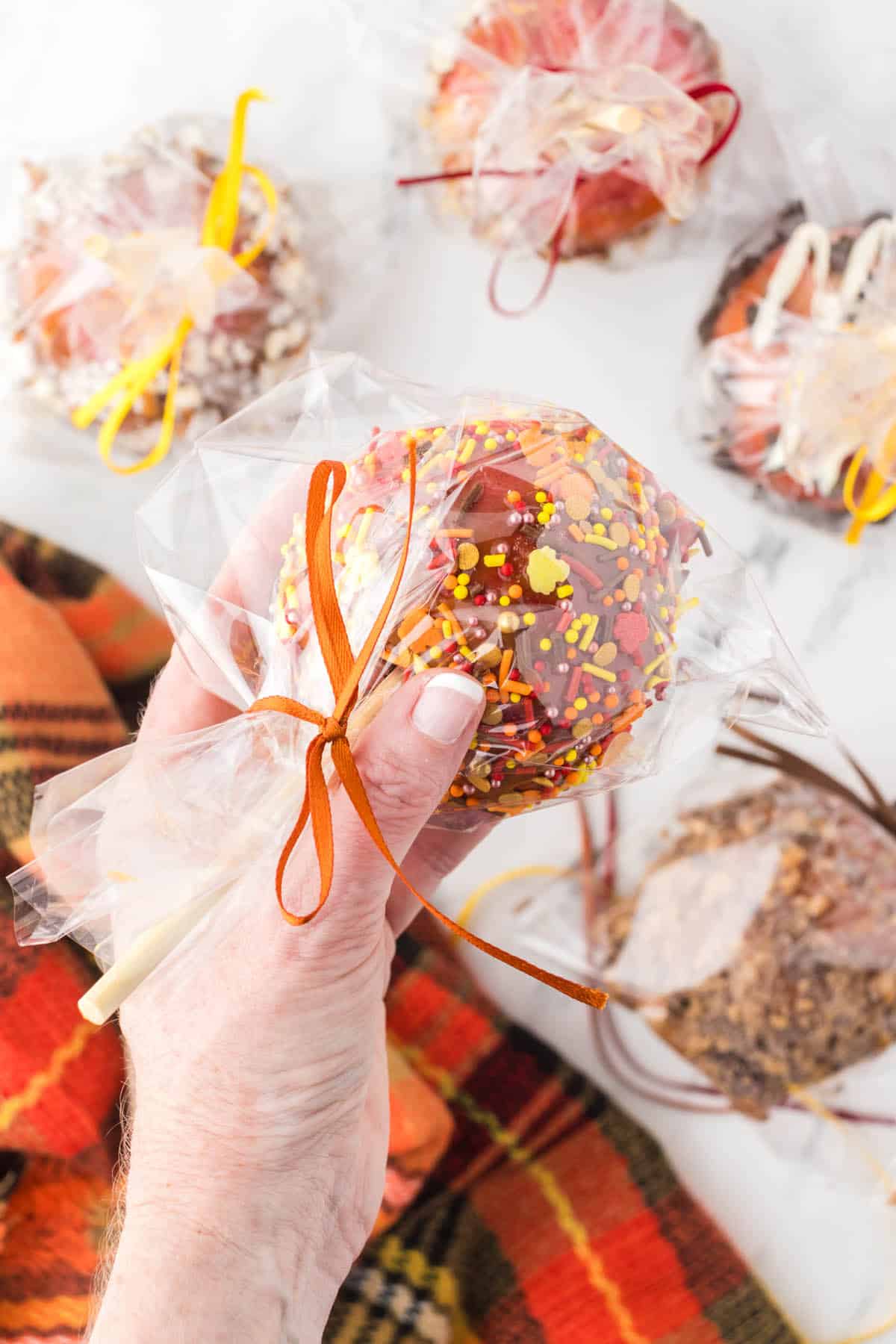 Gourmet caramel apples wrapped in cellophane.