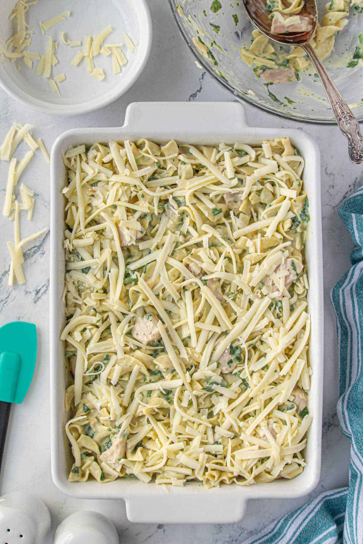 Smoked turkey pasta in a casserole topped with gruyere cheese. It's ready to put into the oven.