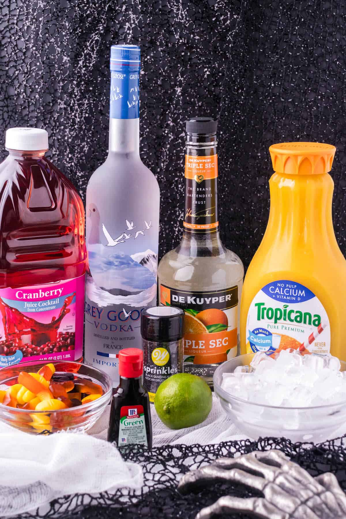 All of the ingredients needed to make the cocktail, including fun garnishes.