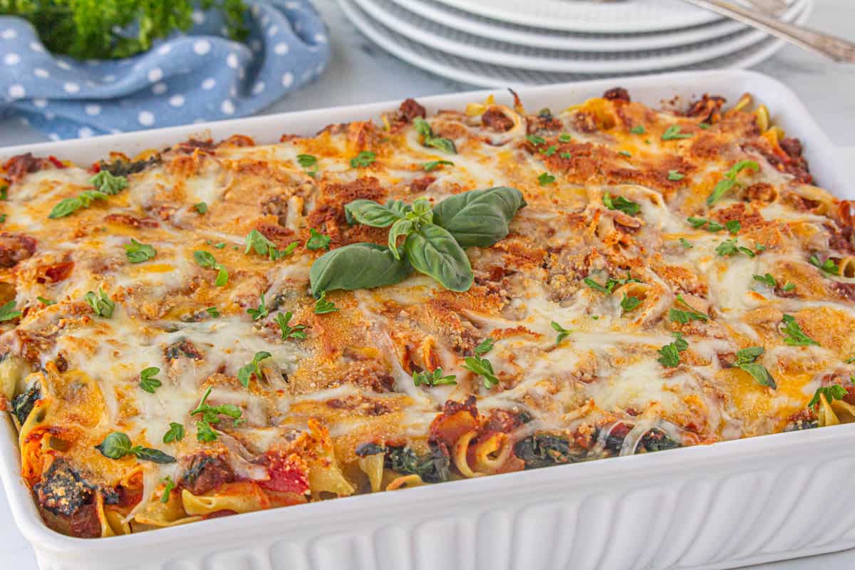 8 layer noodle casserole in a baking dish that has been baked until golden brown.