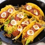 Crunchy tacos decorated with Halloween faces.