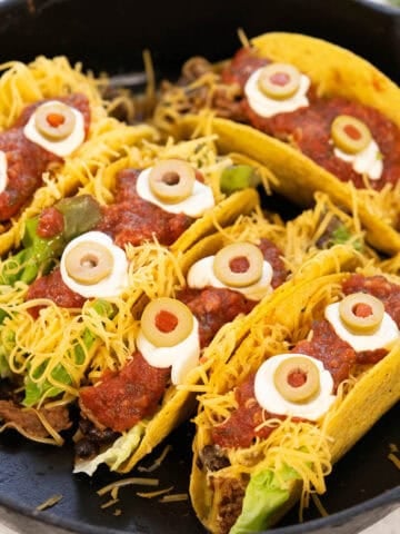 Crunchy tacos decorated with Halloween faces.