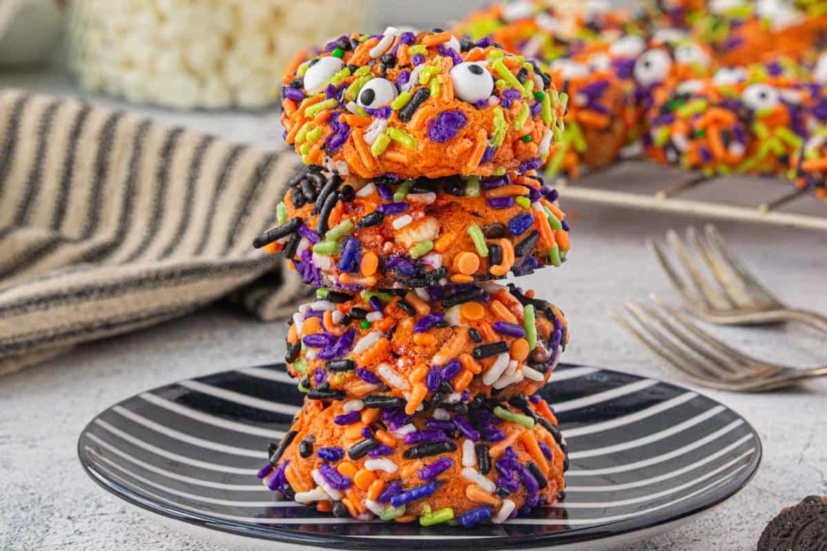 A stack of Halloween Monster Cookies on a plate.