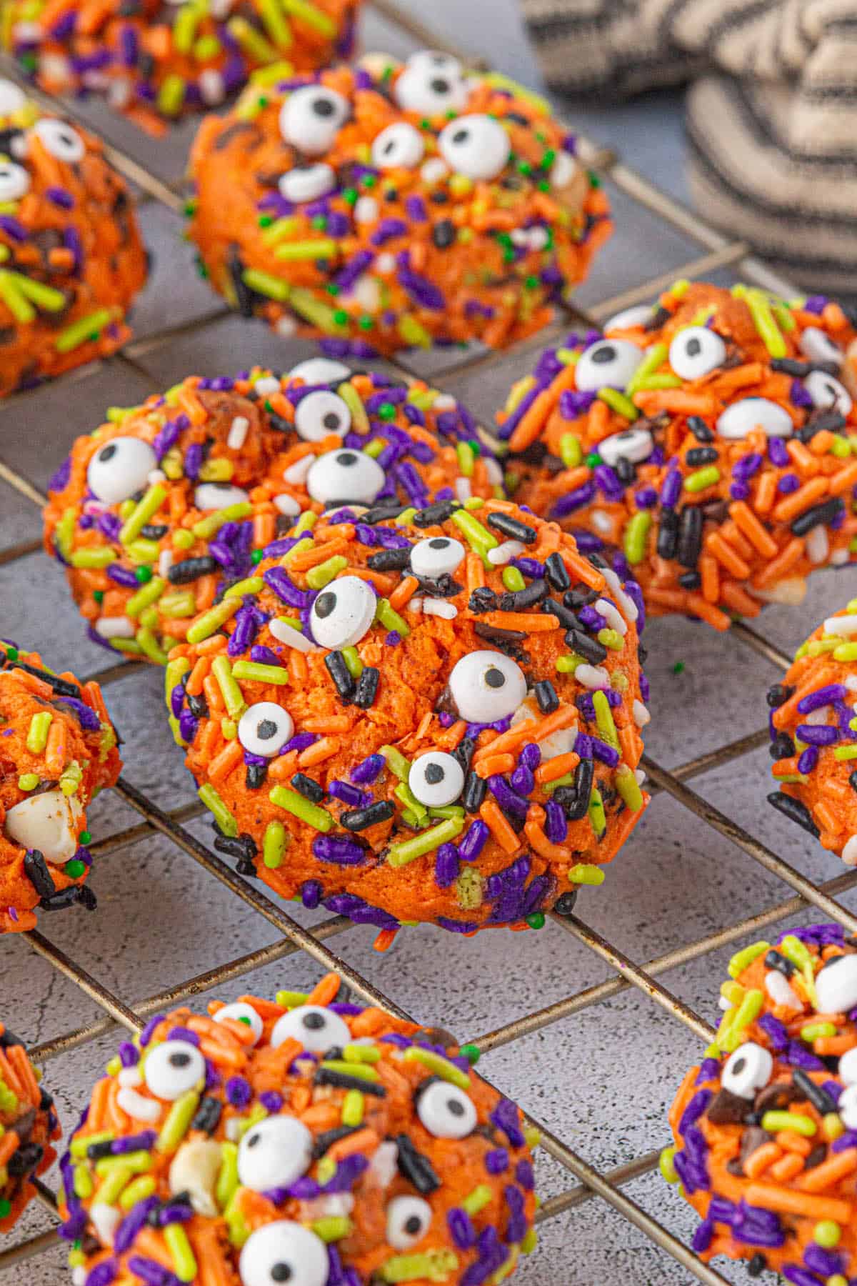 Halloween monster cookies on a cooling rack.