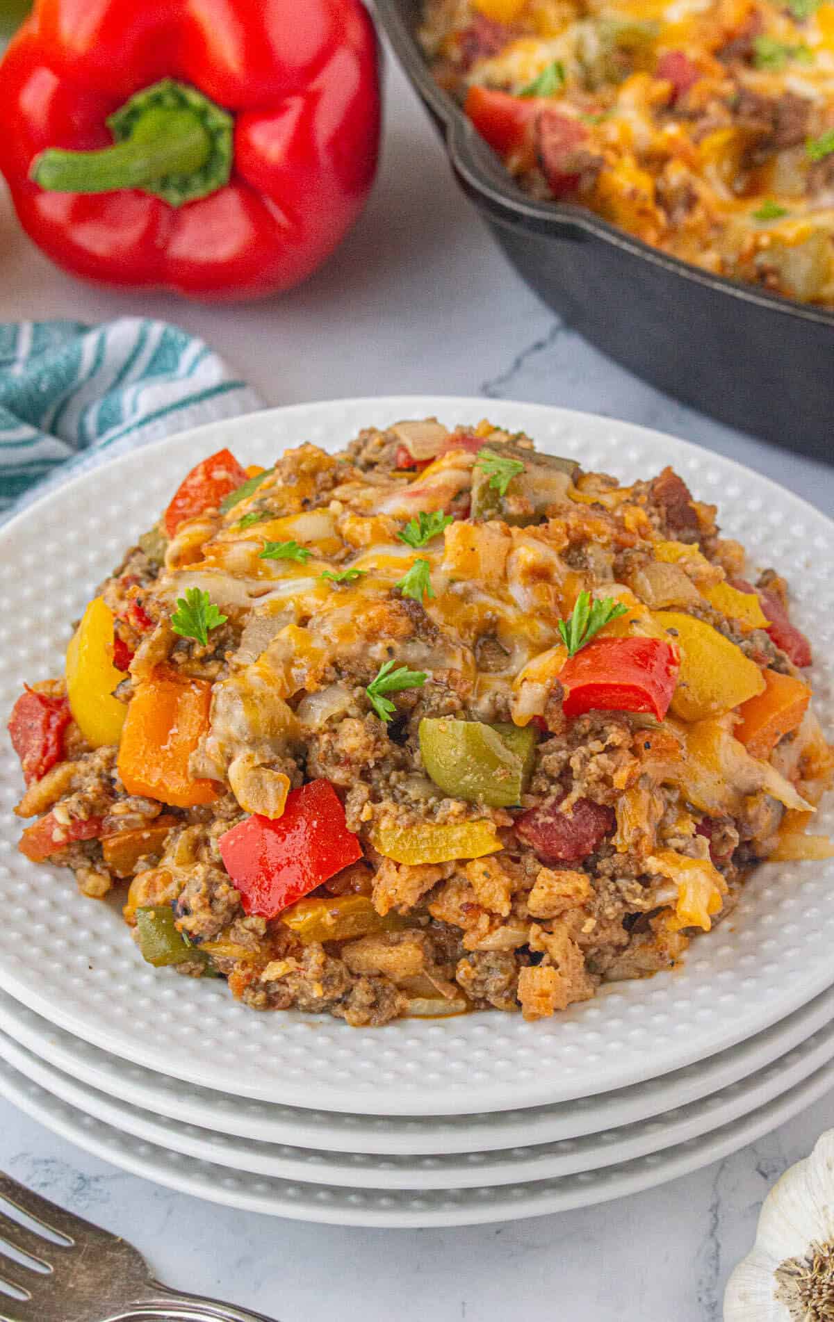 Stove top pepper casserole on a plate, with a fork.