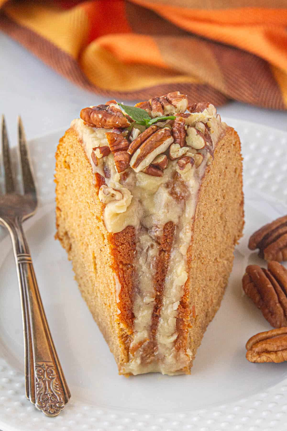 A slice of sweet potato bundt cake on a plate with a fork.