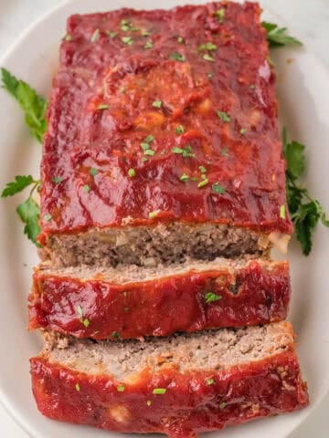 Sliced meatloaf on a platter.