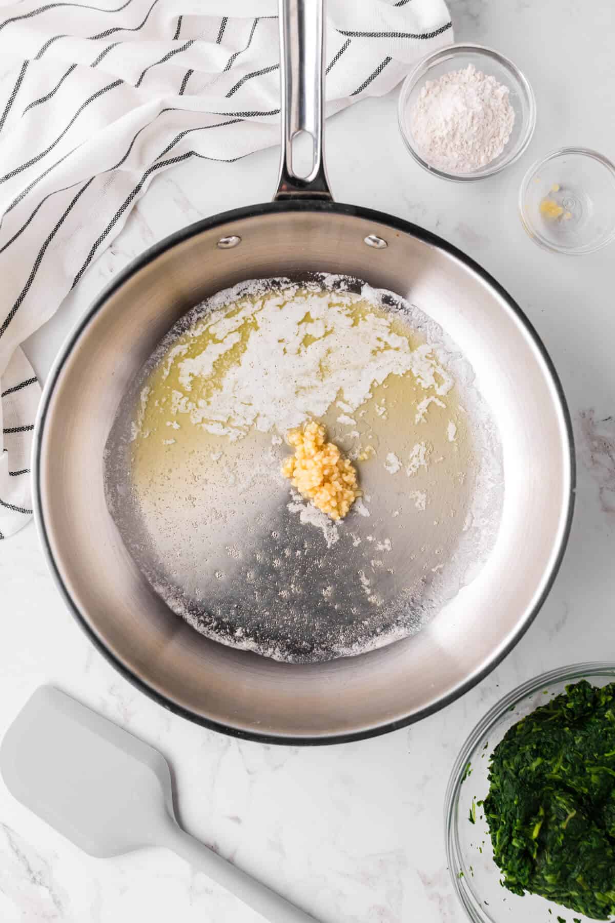 Melted butter in a skillet with garlic.