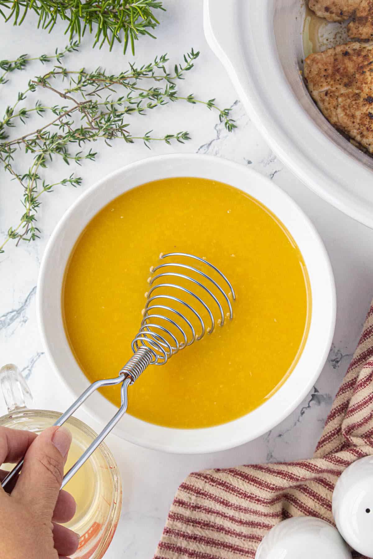 Gravy mix being whisked in a bowl.