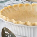 Unbaked pie crust in glass pie dish.