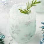 A frothy blended cocktail in a festive holiday glass.