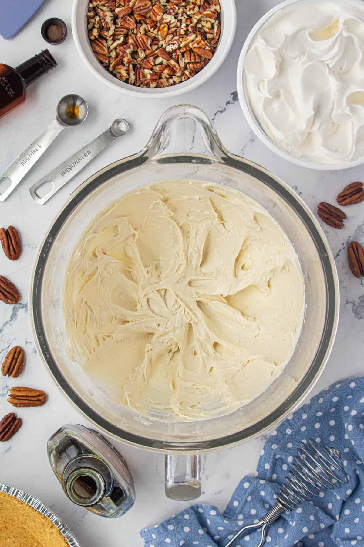 Maple syrup and cream cheese whipped until creamy in a mixing bowl.