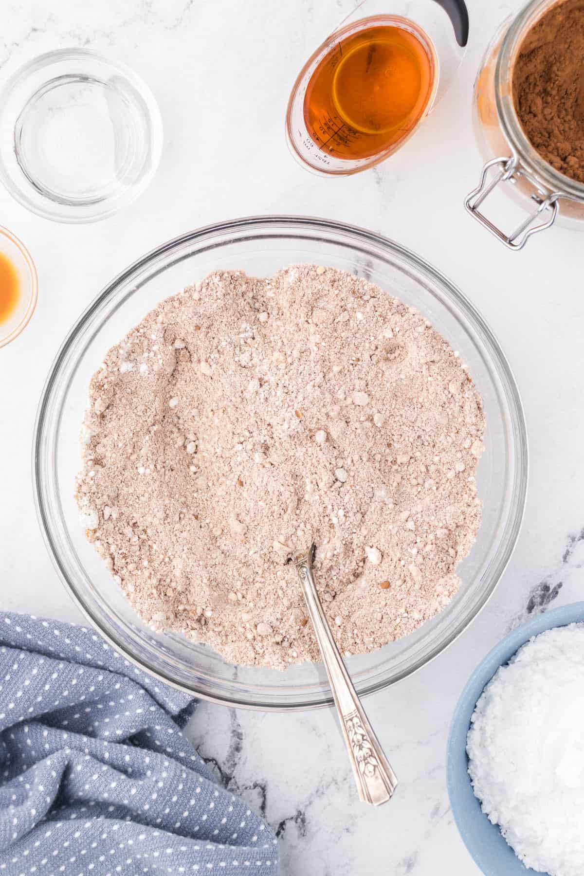 Ingredients in a bowl have been mixed together with a spoon.