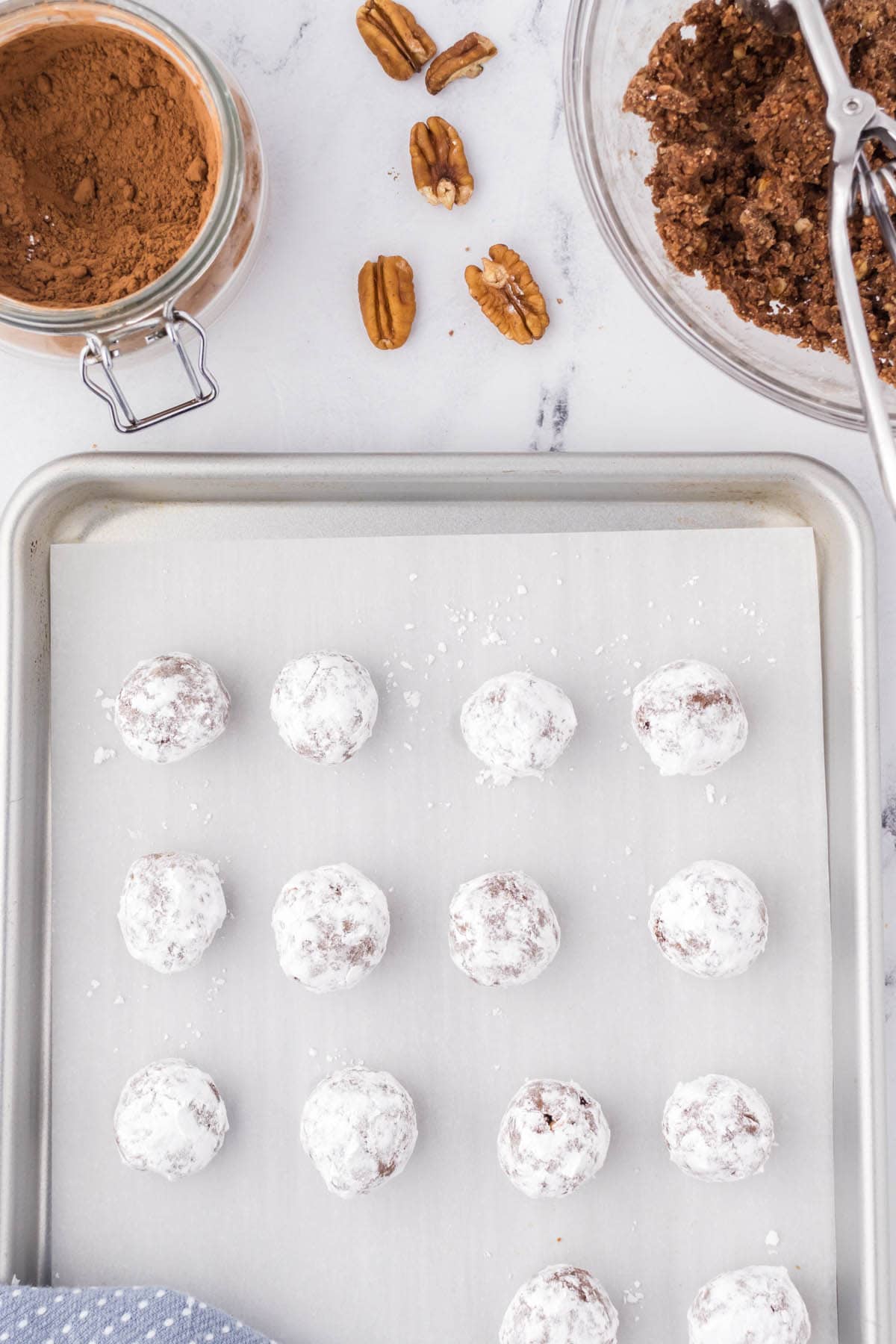 Bourbon balls rolled in sugar then placed on a cookie sheet.