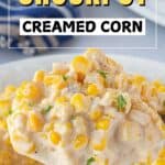 Cream corn in a bowl with a serving spoon. With print overlay for Pinterest.