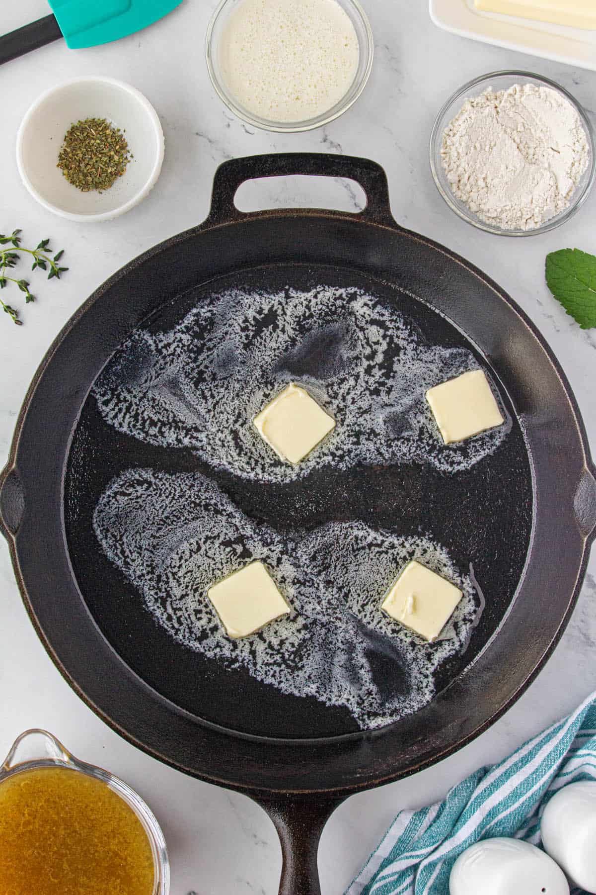 Butter melting in a cast iron skillet.