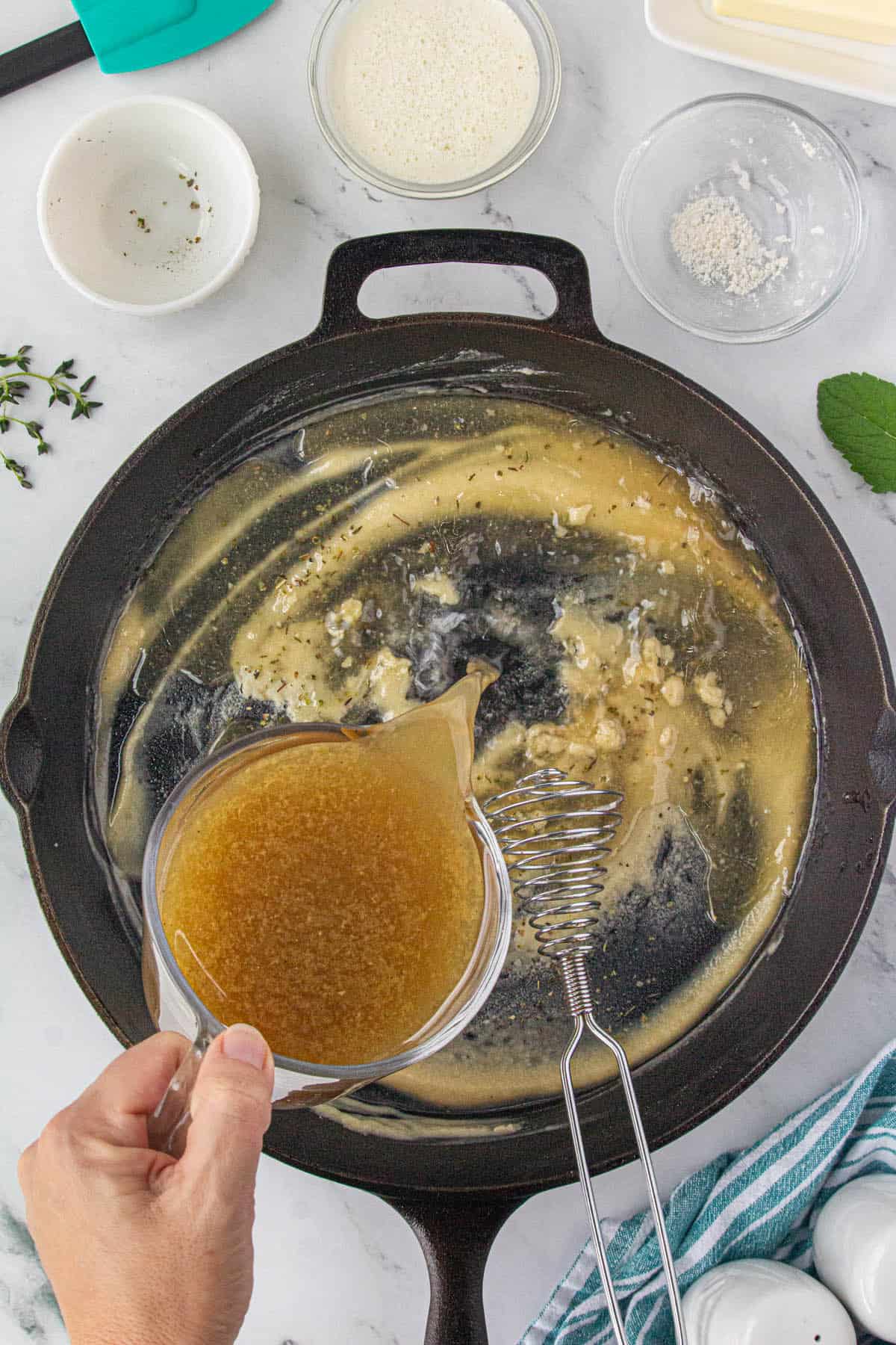 Turkey drippings pouring into a roux.