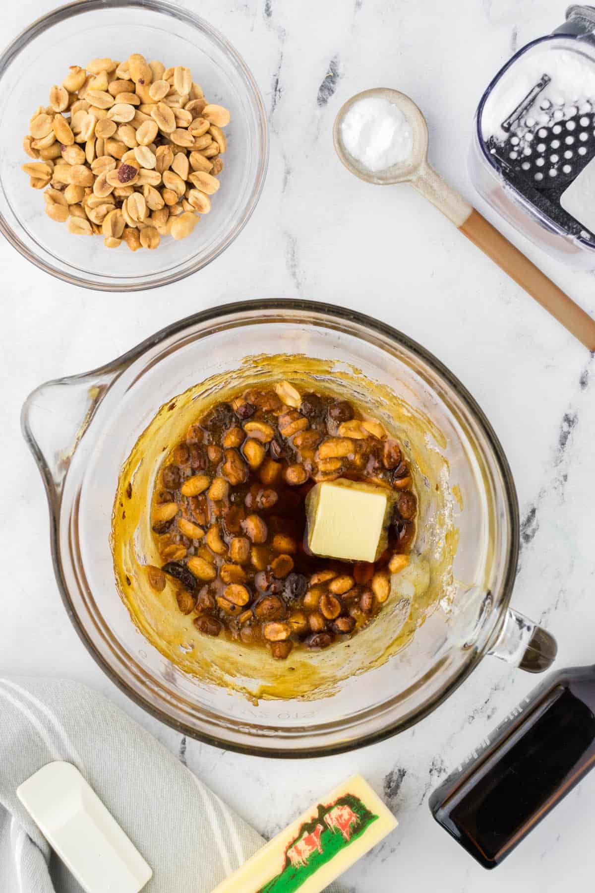 Butter and vanilla added to hot peanut, Karo syrup, and sugar mixture.