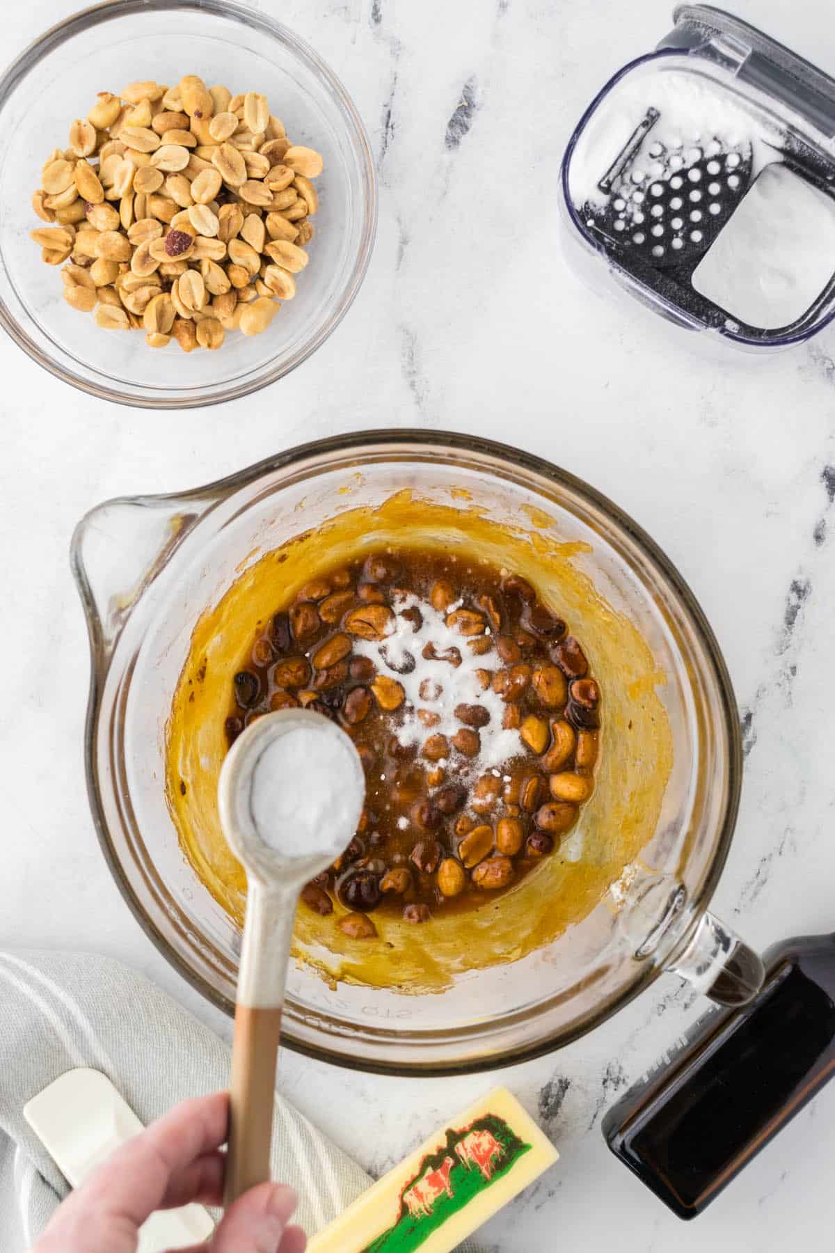 Baking soda being added to a hot peanut, Karo syrup, sugar mixture.