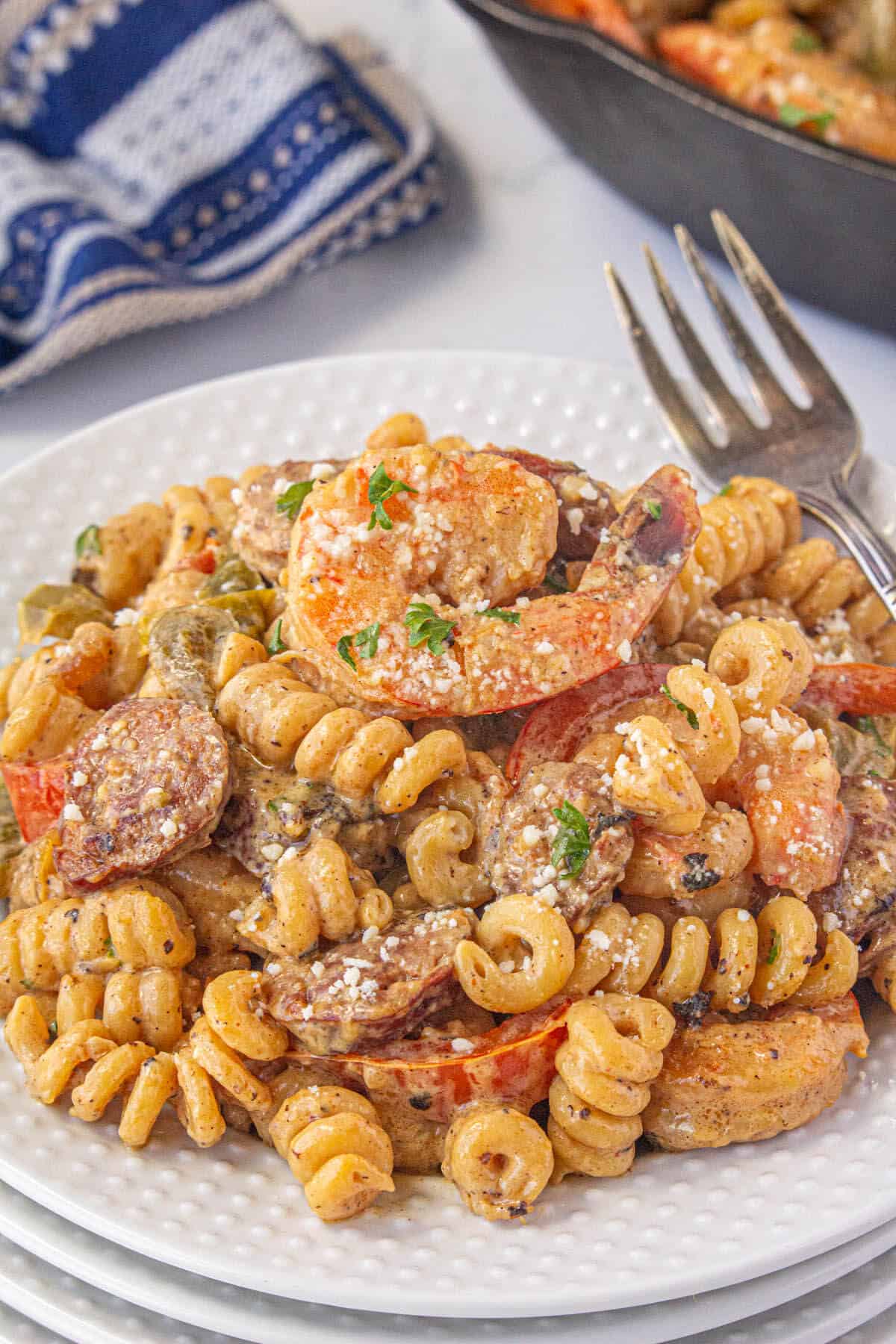 Voodoo pasta on a plate sprinkled with parmesan cheese.